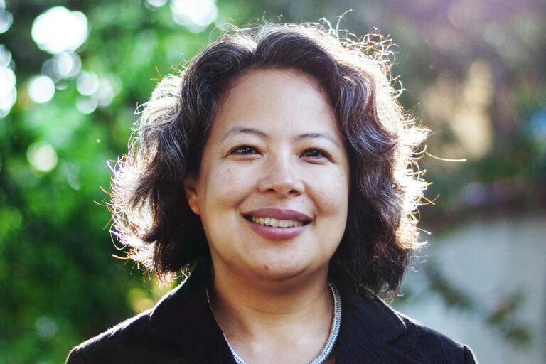 Headshot of Abigail De Kosnik outdoors with trees in background 