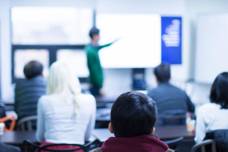 Blurry photo of a student making classroom presentation