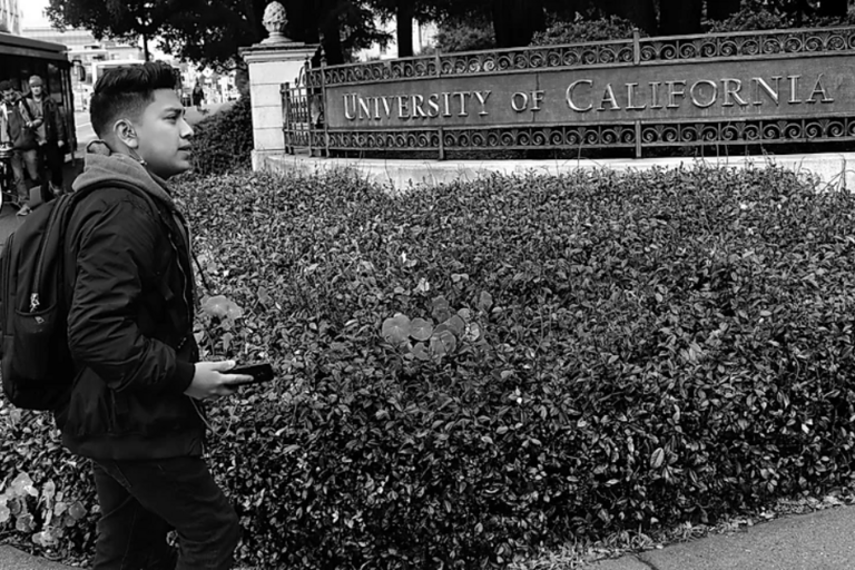 Student stands in front of UC Berkeley West Crescent Entrance